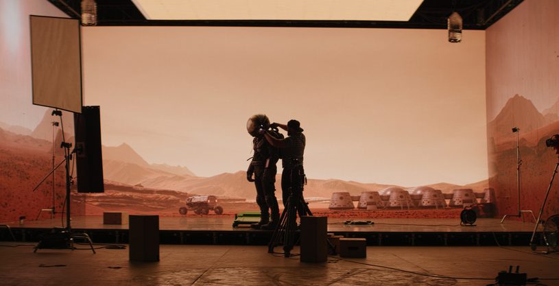 Crew filming on a virtual production set